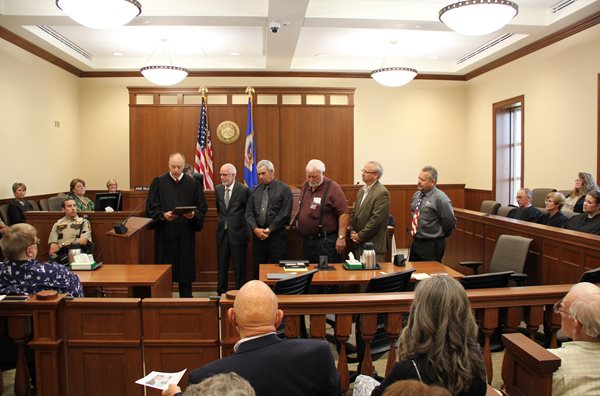 Justice Anderson presents the Dodge County board a commemorative plaque on behalf of the Minnesota Supreme Court.